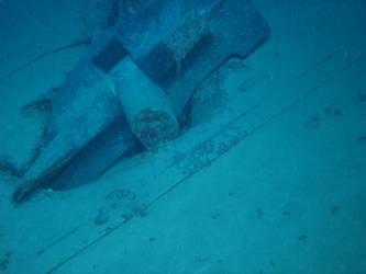 Stbd anchor embedded in steel plate from ship's side in debris field